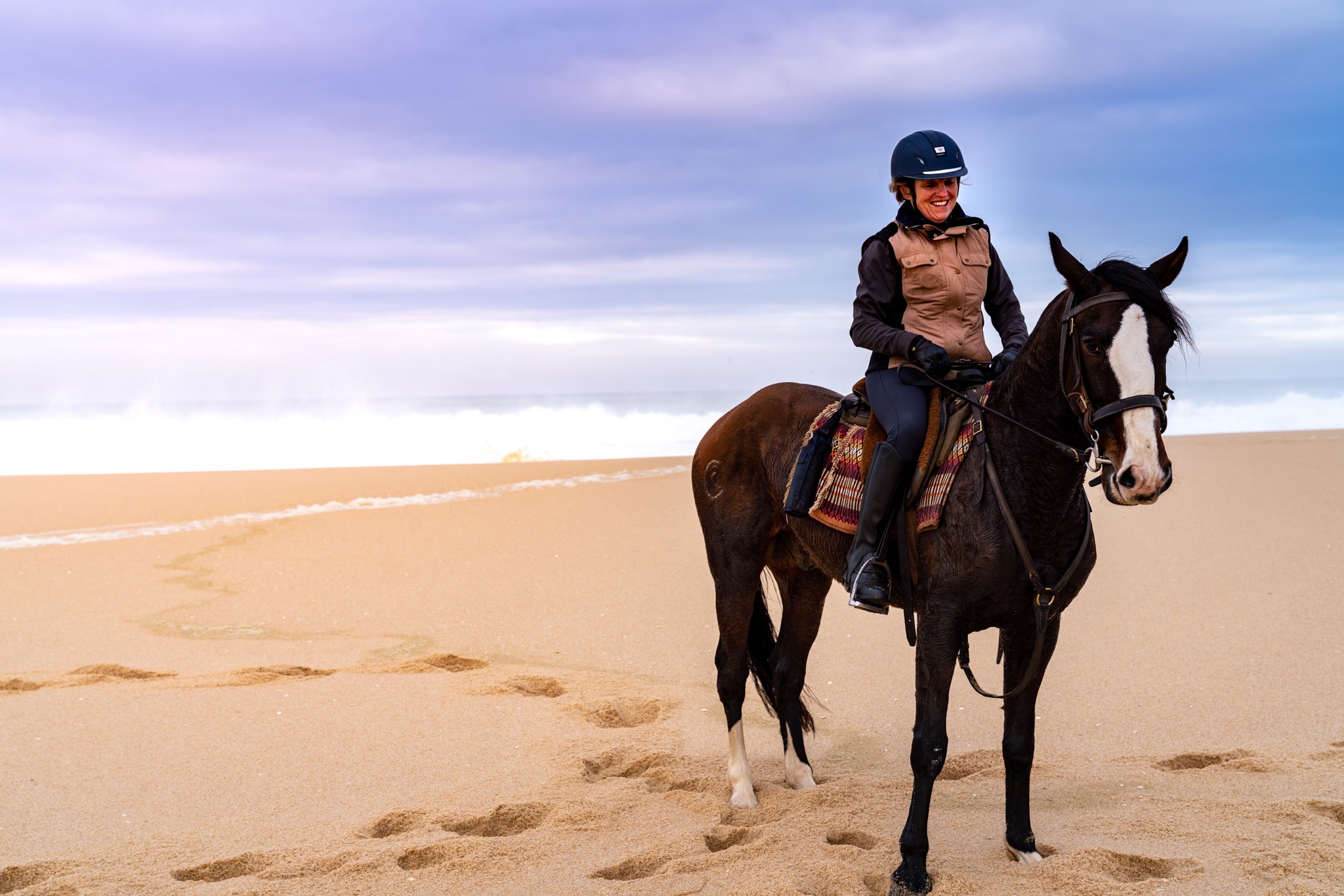 horse and rider on beach with dunes riding holiday portugal by globetrotting