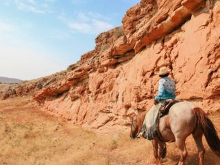 rider in canyon on horse riding holiday Wyoming by globetrotting